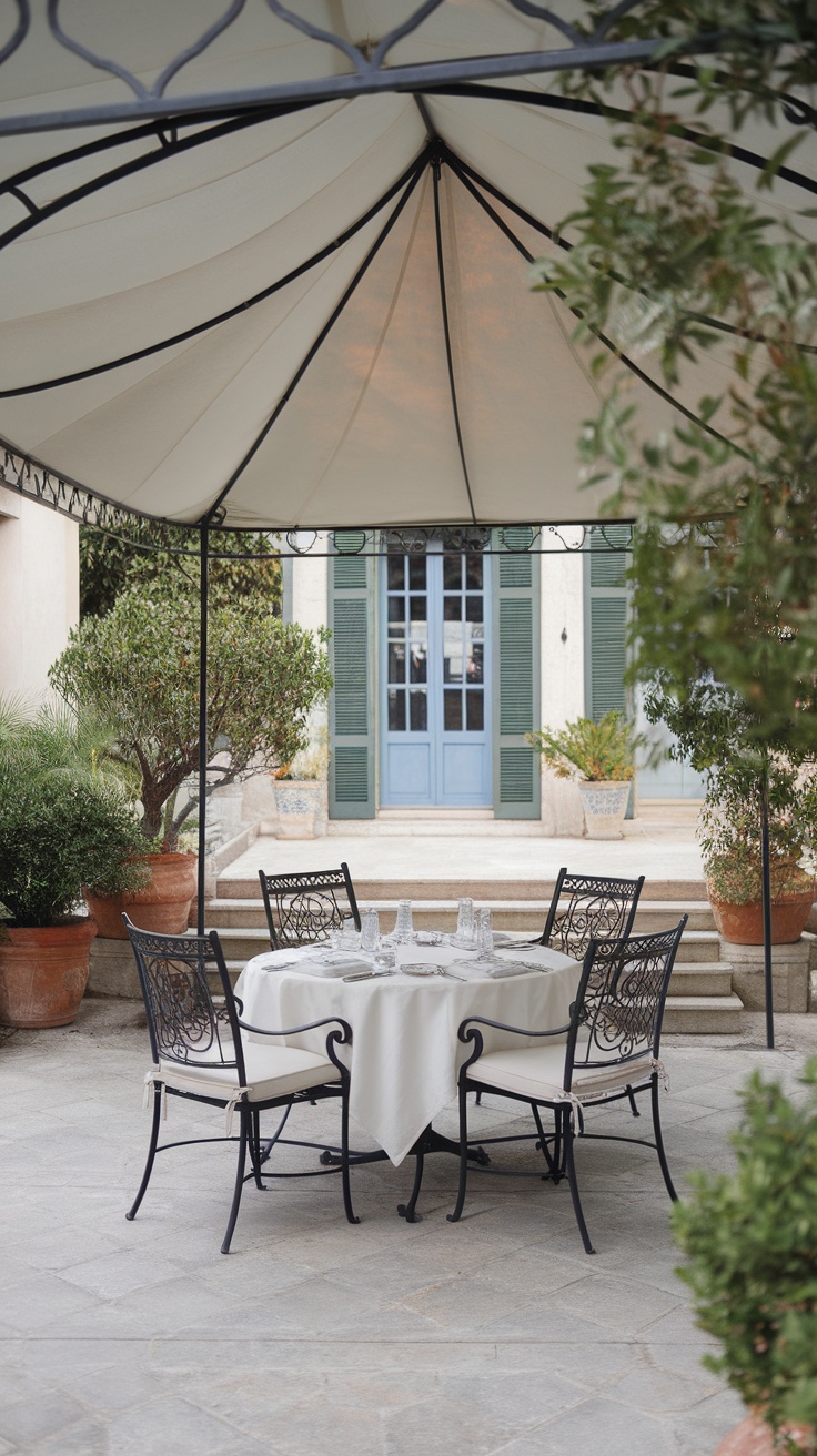 Elegant outdoor dining area with a canopy and black wrought iron chairs.