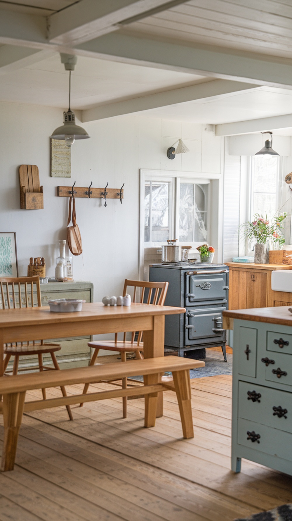 A cozy cottage core kitchen featuring a wooden table and chairs, vintage stove, and bright natural light.